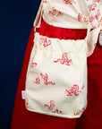 Red dragon print bag and shirt detail