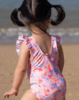 Girl in pink swimsuit at the beach