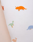 Close-up of exploded pillow with dinosaur pattern.