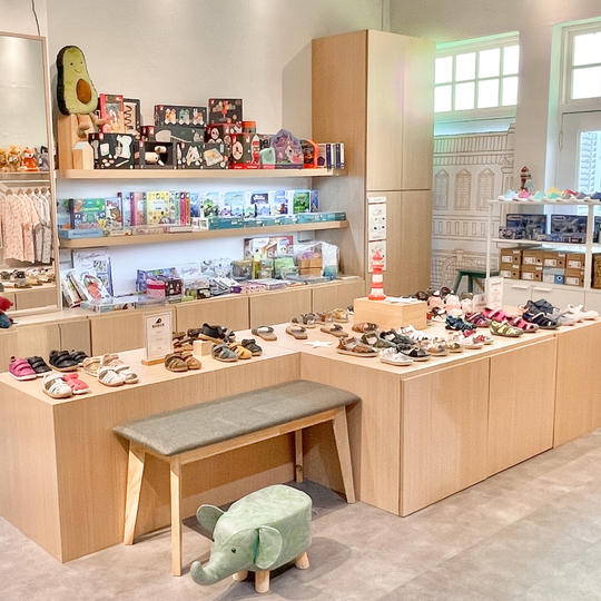 Flagship store interior with children's shoes and books.