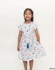 Young girl wearing a hailey dress in nautical mickey on a white background