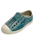 Angled view of teal blue casual slip-on shoes with perforated upper and rounded toe