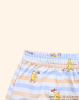 Close-up of elastic waistband on baby leggings with blue stripes and Pooh design