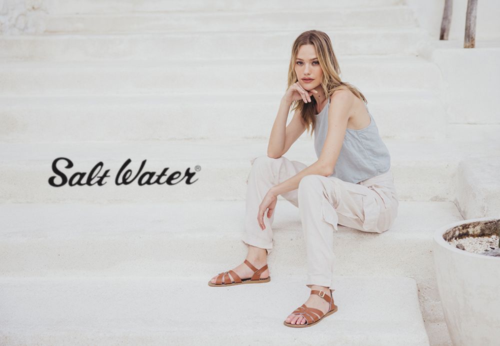 Woman in sandals sitting on steps
