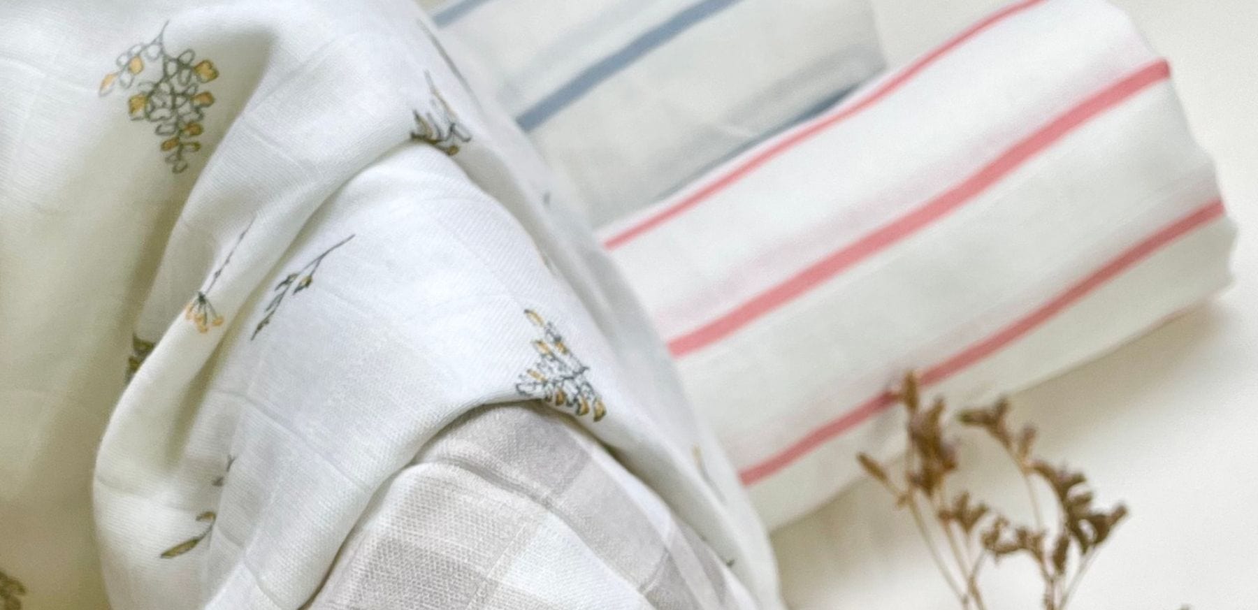 Bamboo swaddle blankets in floral, stripe, and check patterns.