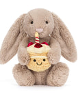 Beige bunny plush toy holding birthday cupcake