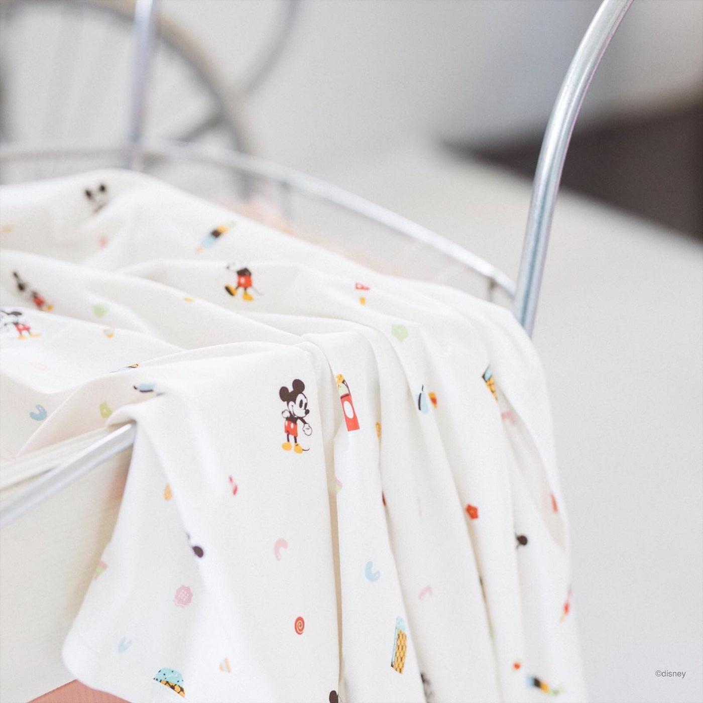 Mickey Mouse baby blanket in a crib