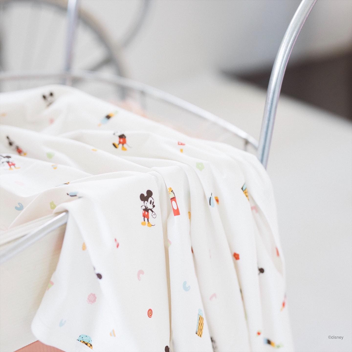 Mickey Mouse baby blanket in a crib