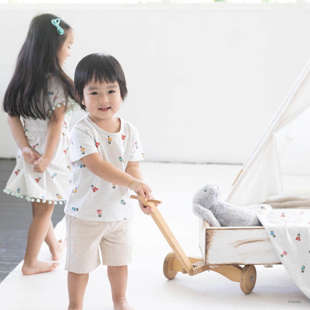 Children playing with blankets and toy wagon