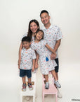 Family of four wearing matching sailor mickey stripes outfits with a white background