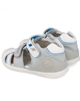 Children's sandal with gray and white and blue accent design on a white background