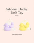 Two pairs of silicone rubber ducks in light purple and bright yellow, each pair packaged in a small mesh drawstring bag.