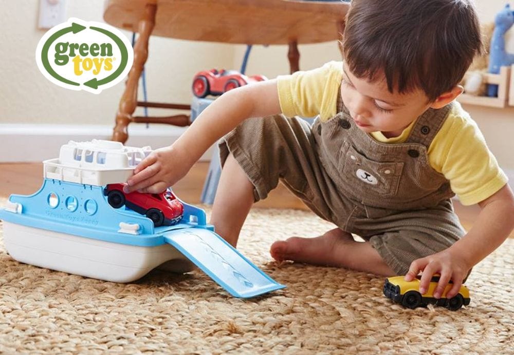 child playing with toy boat and cars