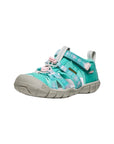 Low-profile side view of the Bright Aqua hybrid sandal, highlighting the flexible CNX sole and the pink-lined adjustable ankle strap.