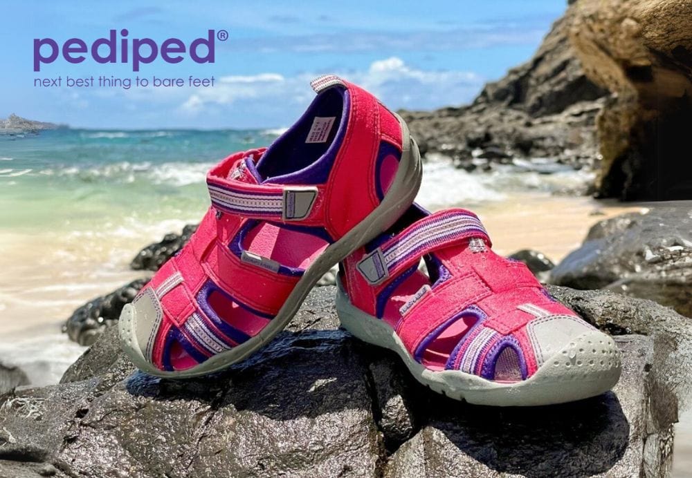 Pediped sandals on beach background