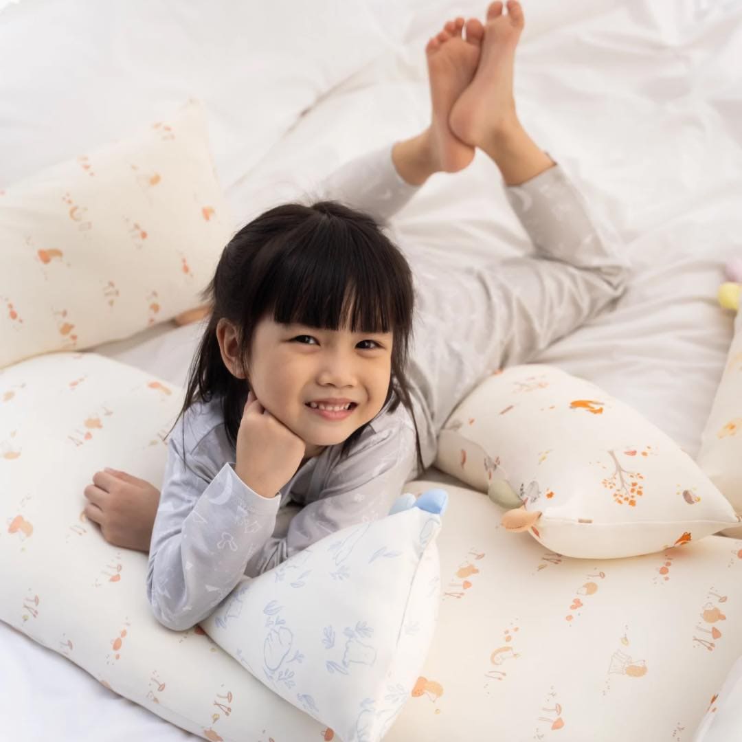 Happy child on bed with pillows