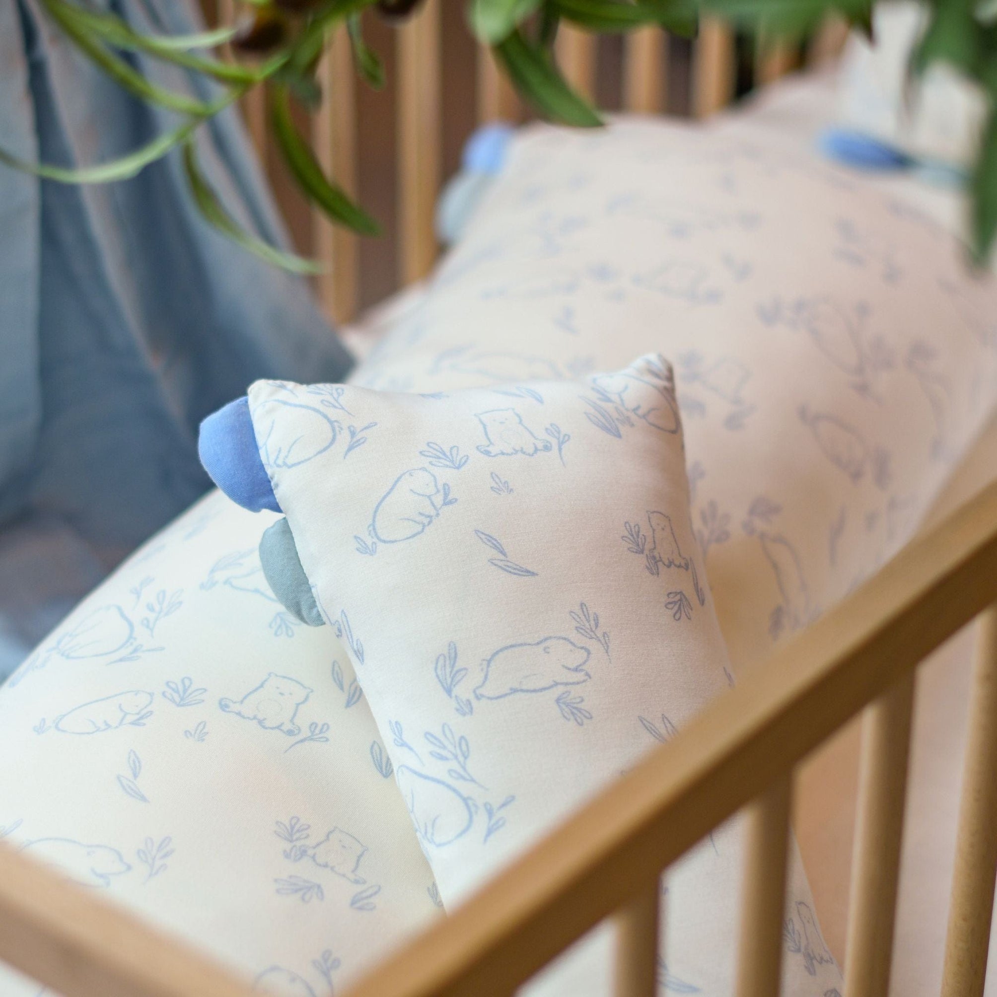 blue patterned pillows in crib