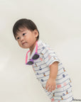 Child wearing Short-Sleeve Polo Romper - Nautical Mickey with sunglasses on a plain background