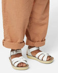 White kids sandals on feet