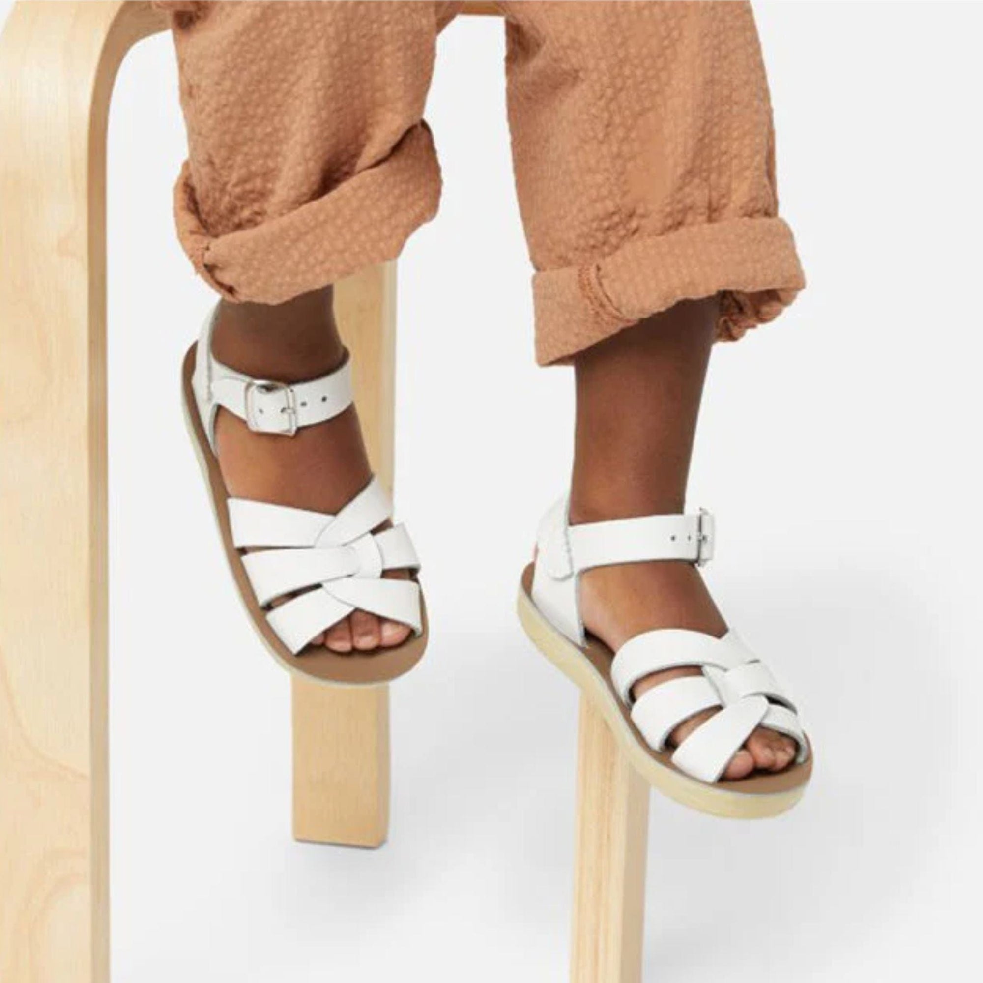 White Saltwater sandals on child's feet
