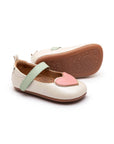 Antique white leather baby Mary Janes with a pink heart detail on the toe and a soft mint green adjustable strap.
