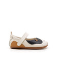 Side profile of the baby Kitten Mary Jane in Tapioca, showing the Hay brown heel accent and slim ergonomic sole.