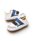 Angled view of the baby Landy sneakers in white and navy, showing the wide toe box and sporty leather panels.