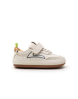 Side profile of the baby Outline sneaker in tapioca leather showing the slim, flexible barefoot flat sole.