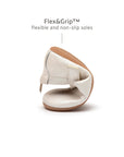 Demonstrating the flexible FlexiGrip rubber sole on the white dream baby shoe for natural barefoot movement.