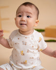 Smiling baby in Winnie the Pooh outfit