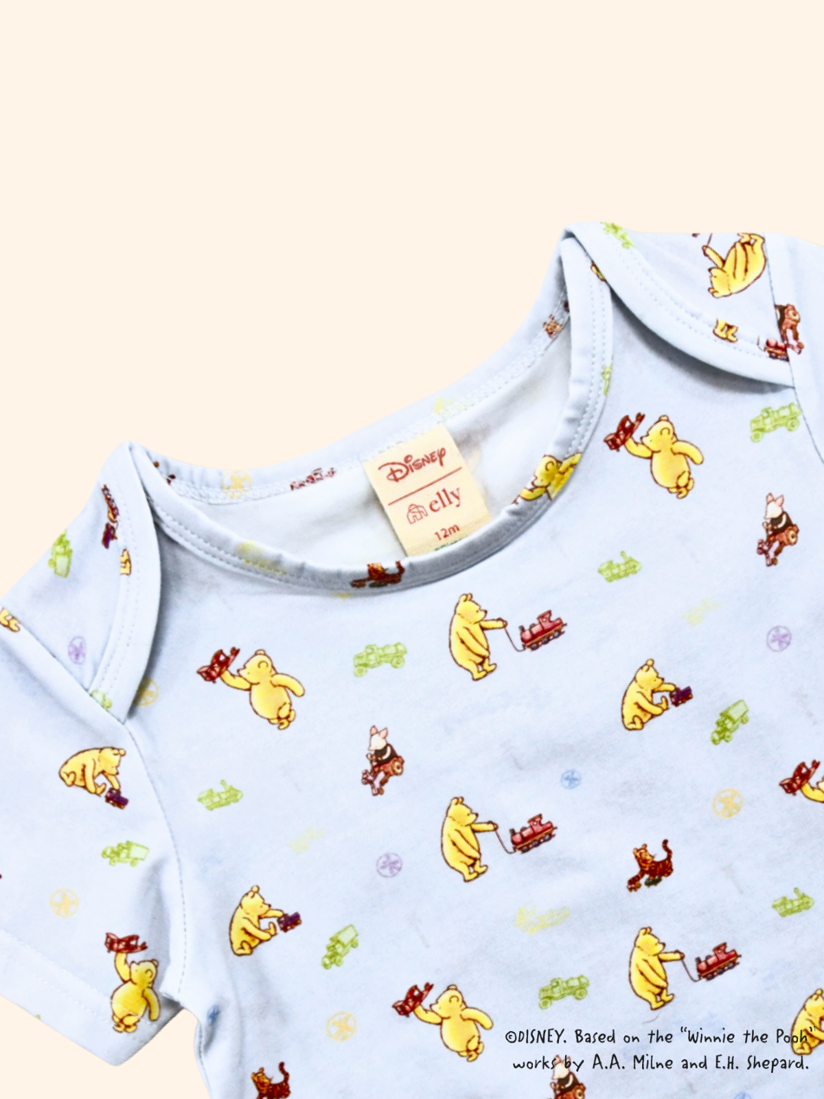 Close-up of baby tee with Classic Pooh print, soft cotton fabric and gentle neckline