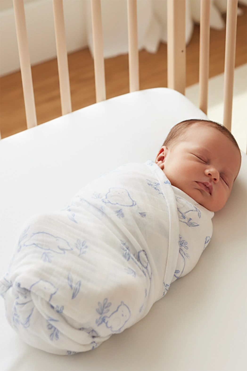 newborn baby swaddled with blue beary best swaddle