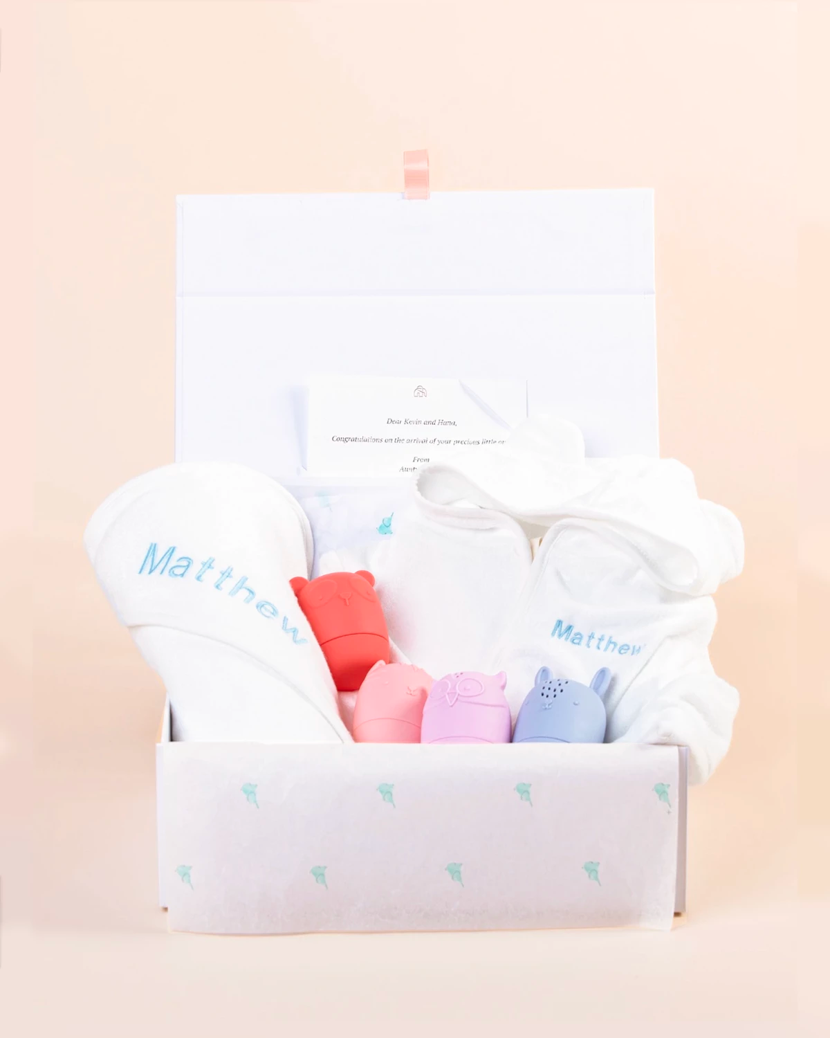 Personalised baby gift set with embroidered hooded towel and pastel animal toys in keepsake gift box