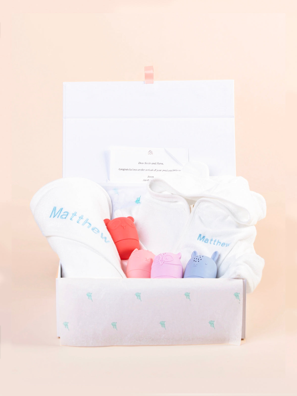 Personalised baby gift set with embroidered hooded towel and pastel animal toys in keepsake gift box