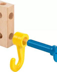 A toy hook with a yellow J-shaped hook and blue screw post, attached to a natural wood peg block on a white background.