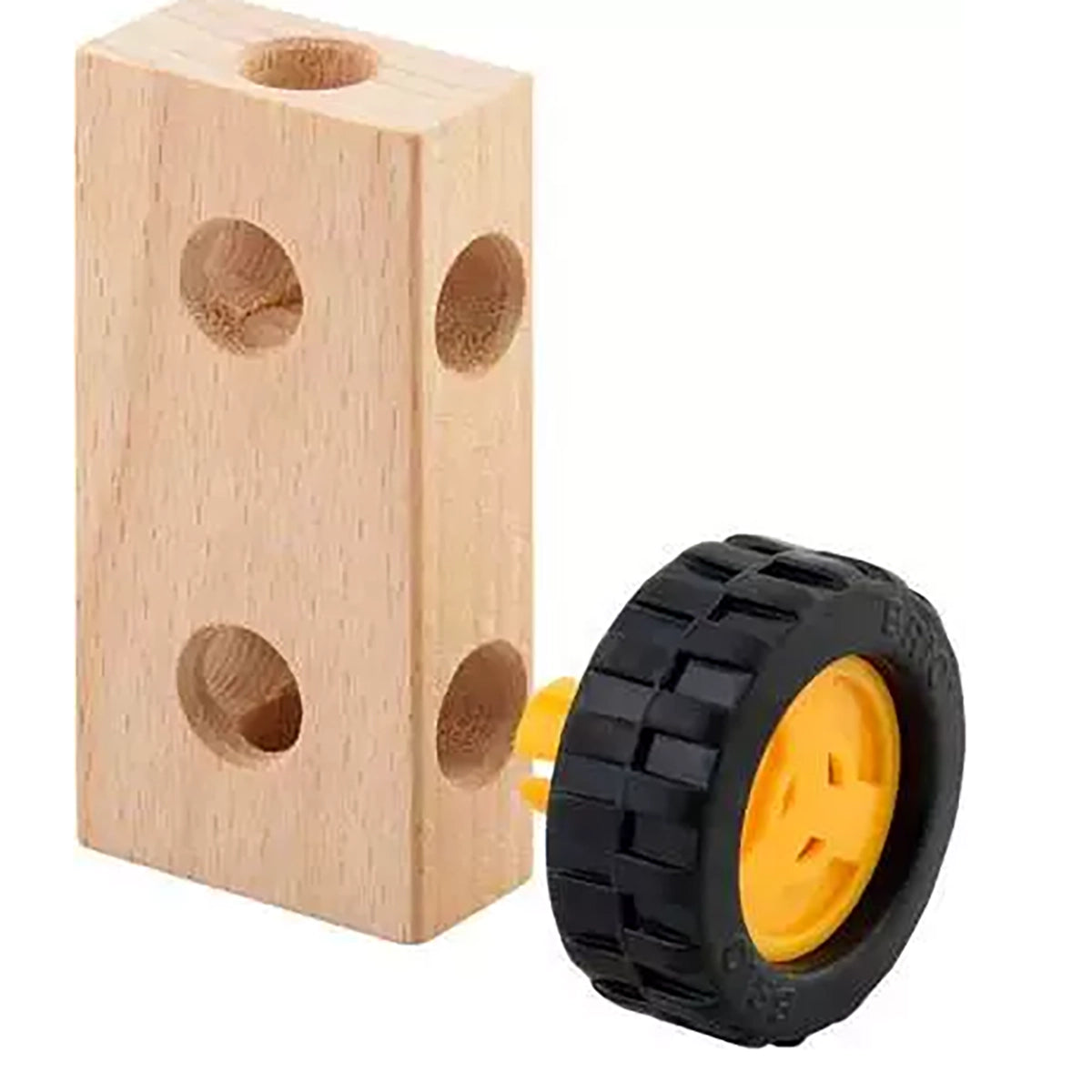 A wooden toy block with pre-drilled holes next to a small black tire-shaped wheel with a yellow center, shown on a plain white background.