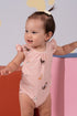 Baby in dog-print onesie smiles, DSC04013