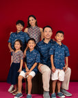 Family portrait in matching outfits on red background