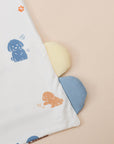 Dog-themed blanket with paw prints and puppy illustrations.