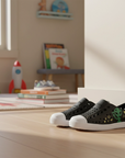 Native children's shoes with alien print and white soles in a nursery