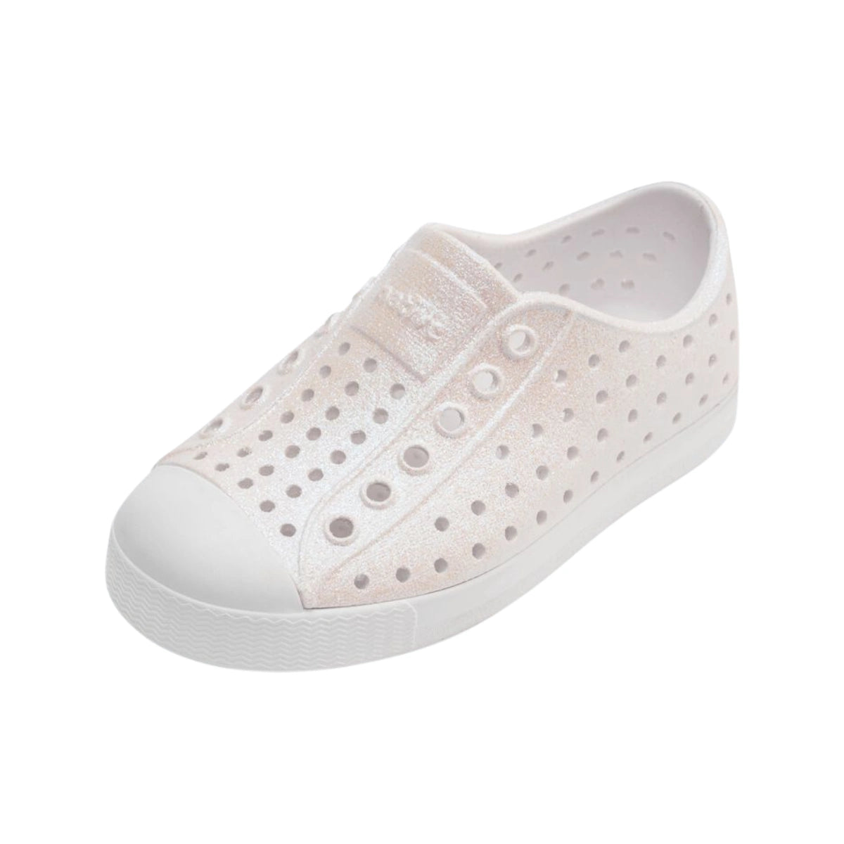 Angled view of white iridescent casual slip-on shoes with perforated upper and rounded toe
