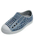 Angled view of denim blue casual slip-on shoes with perforated upper and rounded toe
