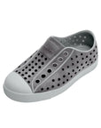 Angled view of grey casual slip-on shoes with perforated upper and rounded toe