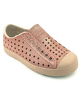 Angled view of dusty pink casual slip-on shoes with perforated upper and rounded toe