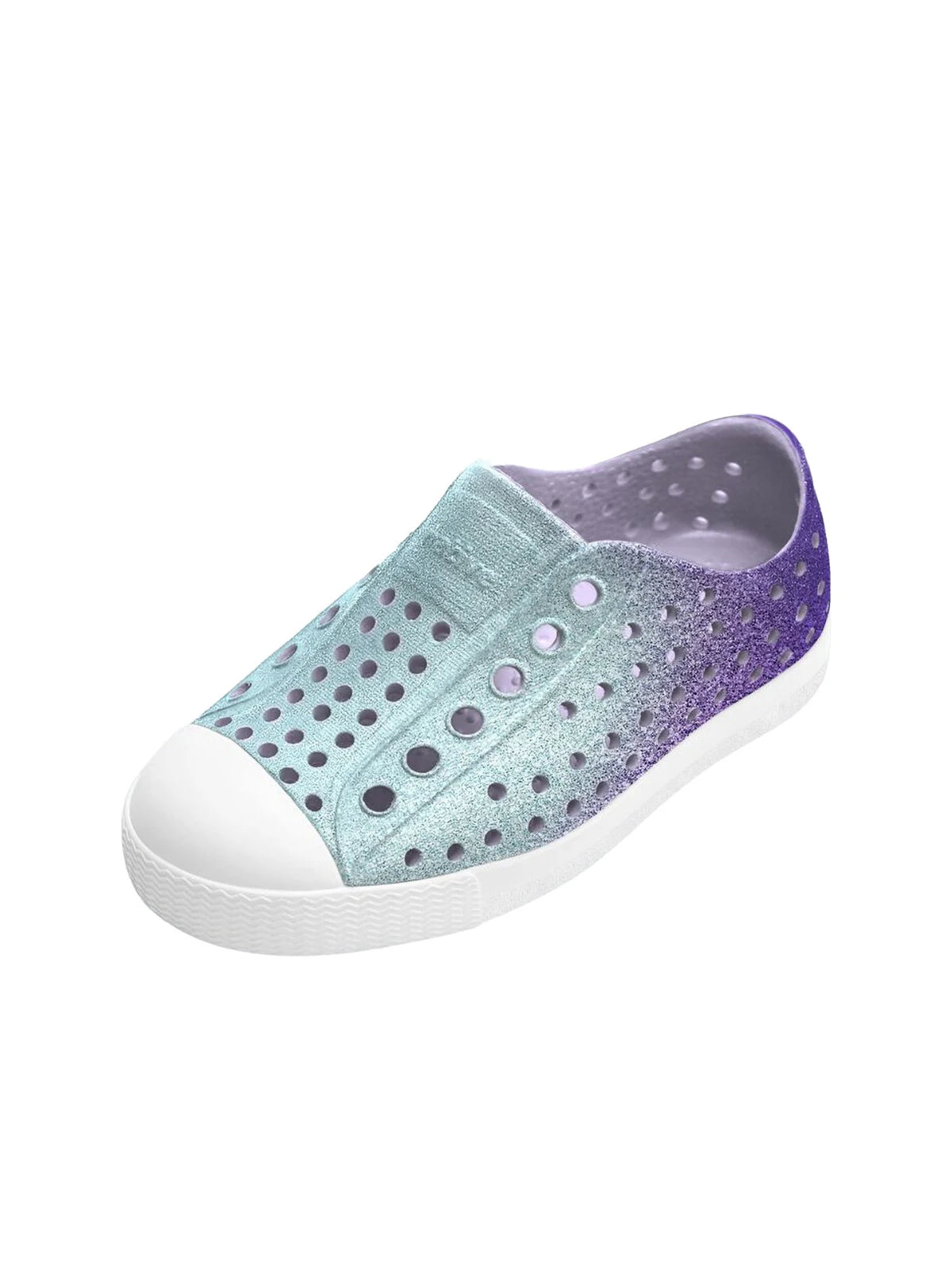 Angled top view of kids' Native Jefferson slip-on shoes showing the perforated breathable design and sparkly purple-blue glitter finish.
