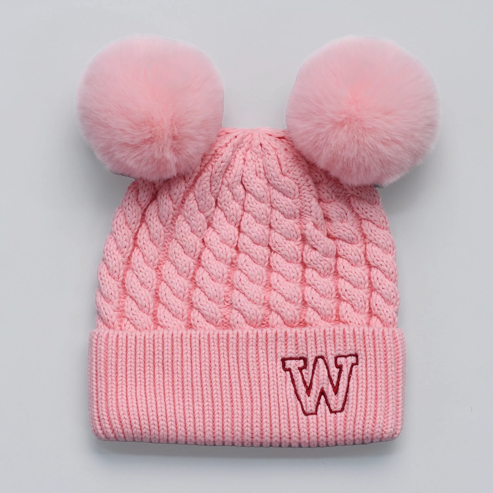 Pink knitted beanie with double pom-poms