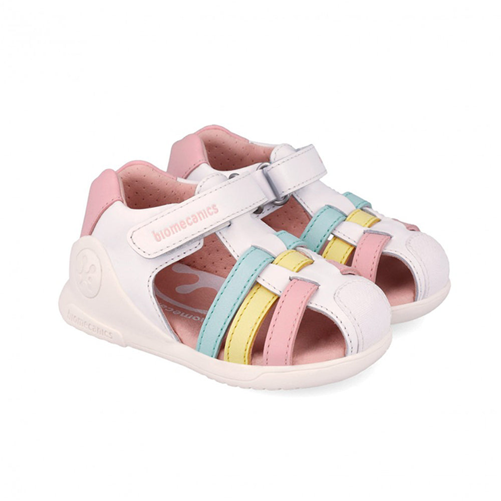 White sandal with pink, blue, and yellow accents on a white background