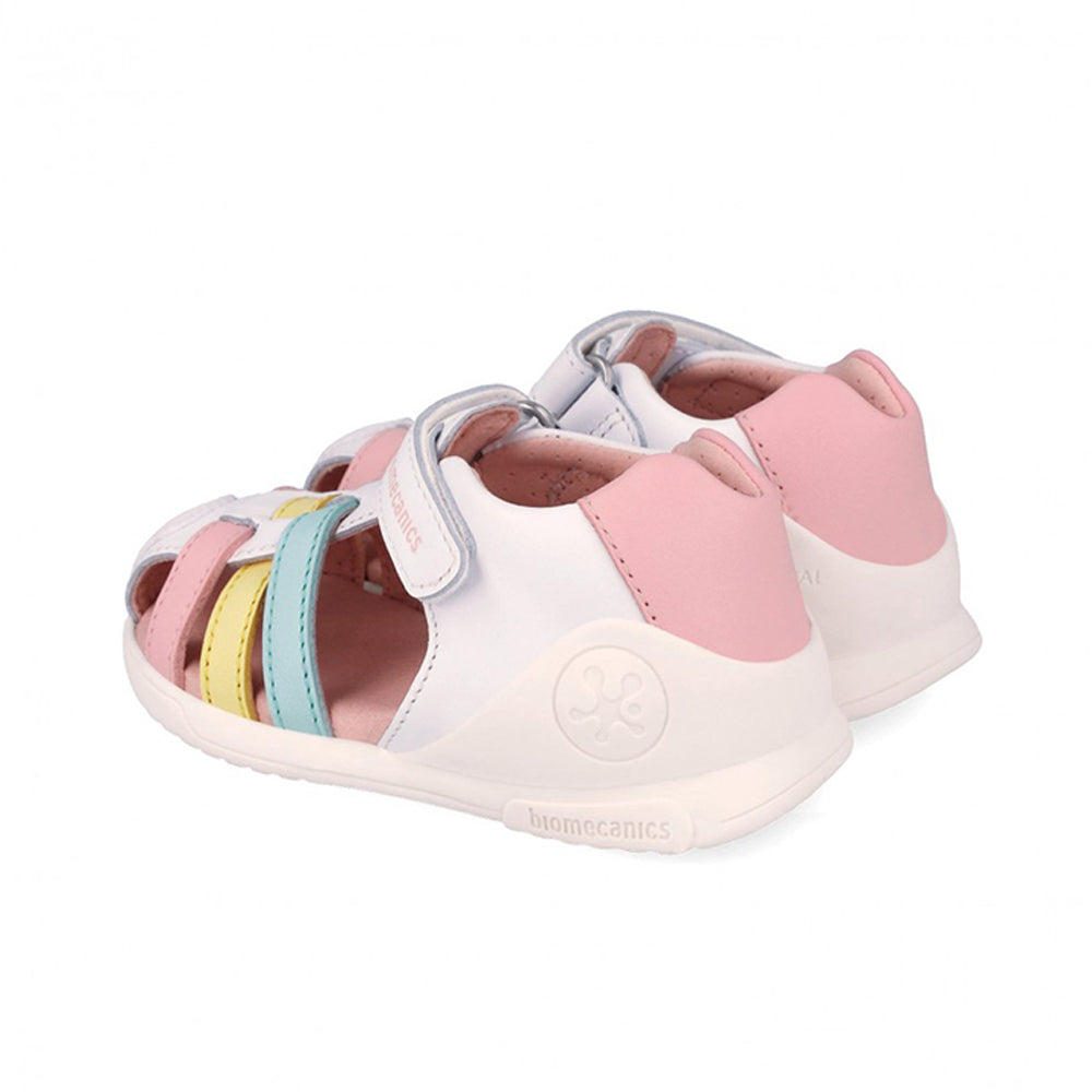 White sandal with pink, blue, and yellow accents on a white background