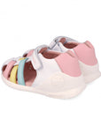 White sandal with pink, blue, and yellow accents on a white background