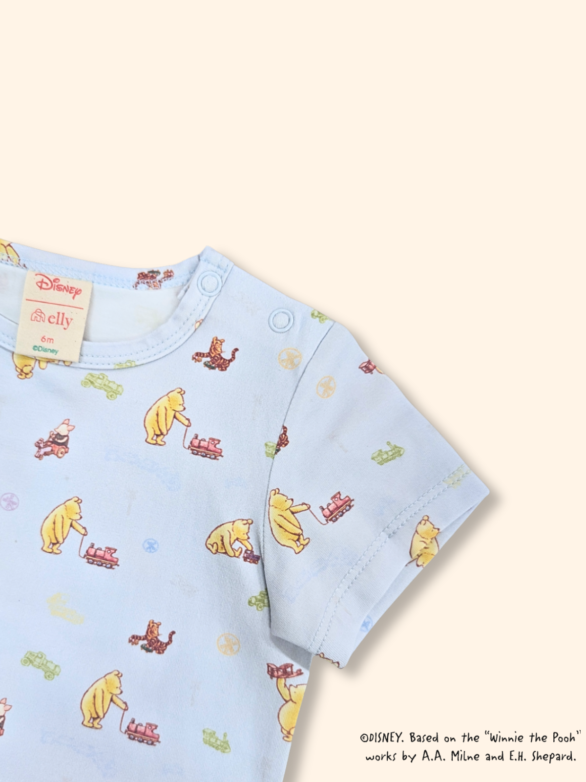 Classic Pooh baby onesie in blue with train print, soft cotton fabric
